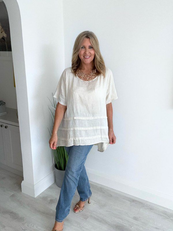 Woman wearing a vintage relaxed fit 100% linen top with short sleeves and oversized silhouette