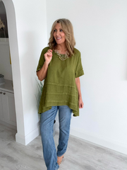 Woman wearing a vintage relaxed fit 100% linen top with short sleeves and oversized silhouette
