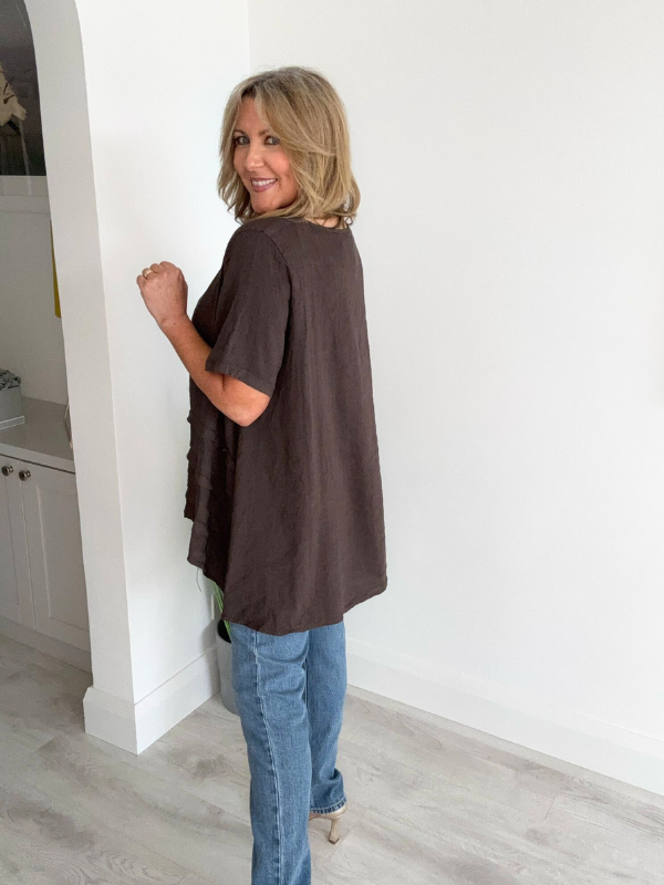 Woman wearing a vintage relaxed fit 100% linen top with short sleeves and oversized silhouette