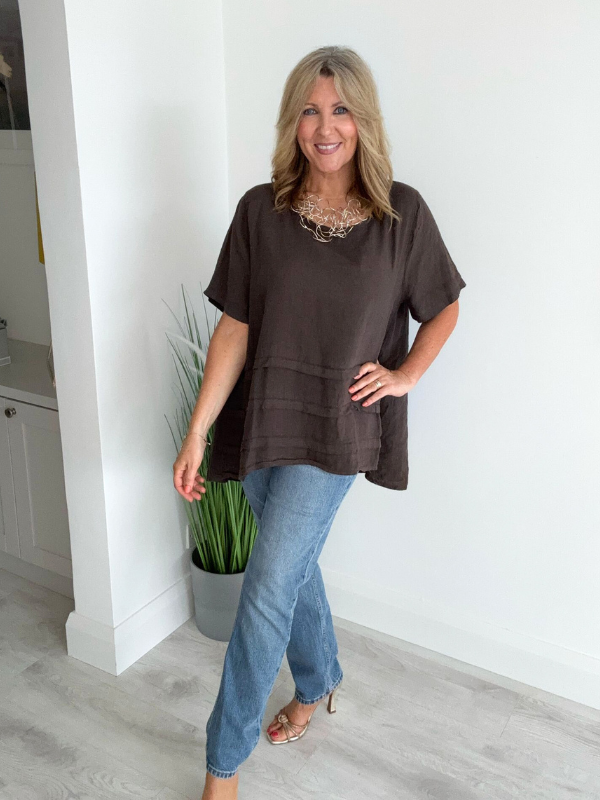 Woman wearing a vintage relaxed fit 100% linen top with short sleeves and oversized silhouette