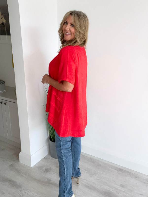 Woman wearing a vintage relaxed fit 100% linen top with short sleeves and oversized silhouette