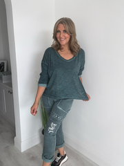 Relaxed fit long sleeve top with a V-neckline, soft washed finish, and breathable fabric, available in multiple colors