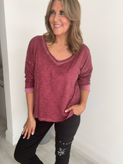 Relaxed fit long sleeve top with a V-neckline, soft washed finish, and breathable fabric, available in multiple colors