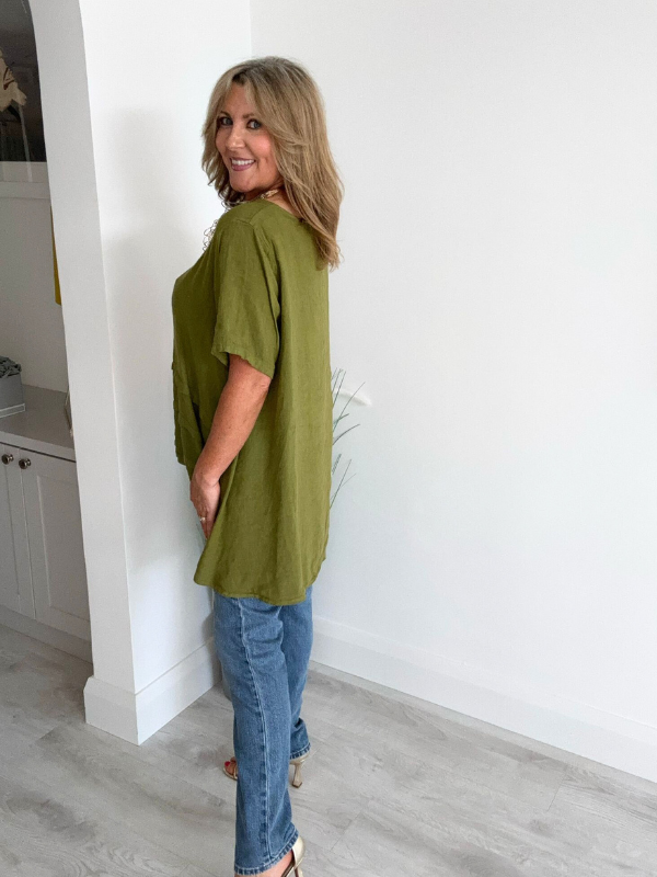 Woman wearing a vintage relaxed fit 100% linen top with short sleeves and oversized silhouette