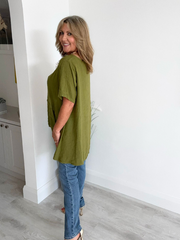 Woman wearing a vintage relaxed fit 100% linen top with short sleeves and oversized silhouette