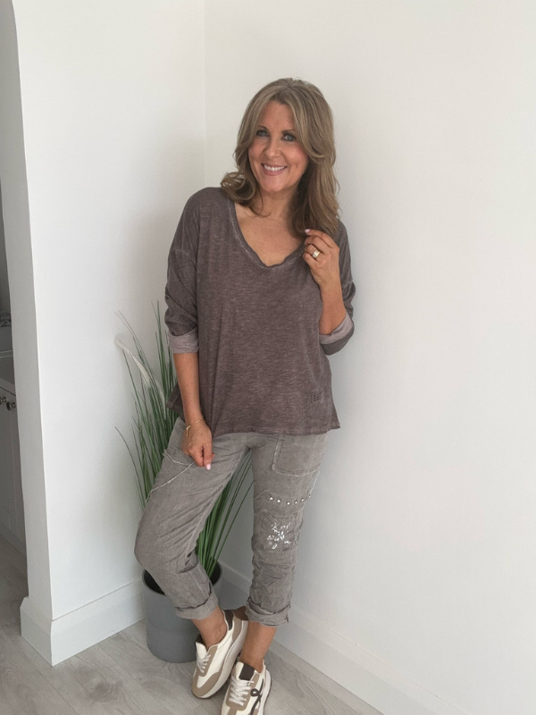 Relaxed fit long sleeve top with a V-neckline, soft washed finish, and breathable fabric, available in multiple colors