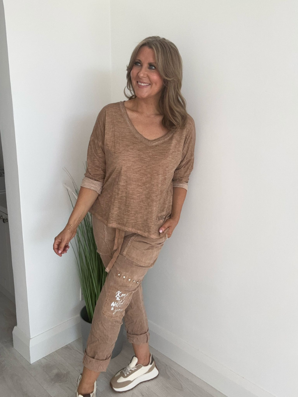 Relaxed fit long sleeve top with a V-neckline, soft washed finish, and breathable fabric, available in multiple colors