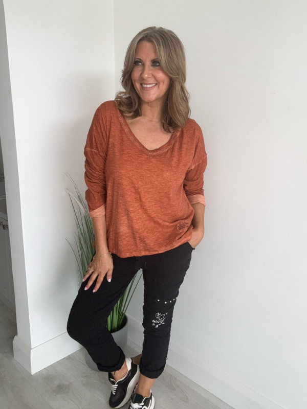 Relaxed fit long sleeve top with a V-neckline, soft washed finish, and breathable fabric, available in multiple colors