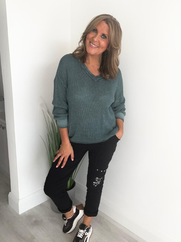 Soft casual knit V-neck sweater with a relaxed fit, ribbed cuffs, and lightweight fabric, perfect for year-round wear
