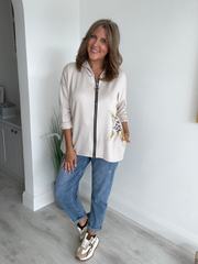 Women's casual zip-up jacket with long sleeves, featuring a decorative star detail on the side, paired with jeans. Available in multiple colors