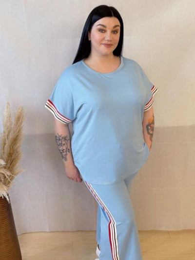 Model wearing a comfortable two-piece co-ord set with stripe trim, Designed for casual wear with a sporty twist.