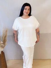 Model wearing a comfortable two-piece co-ord set with stripe trim, Designed for casual wear with a sporty twist.