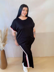 Model wearing a comfortable two-piece co-ord set with stripe trim, Designed for casual wear with a sporty twist.