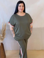 Model wearing a comfortable two-piece co-ord set with stripe trim, Designed for casual wear with a sporty twist.