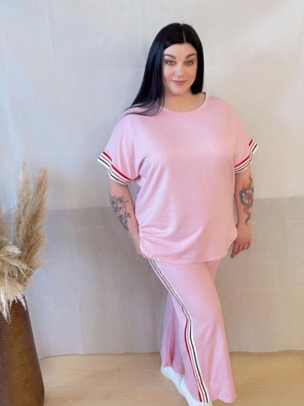 Model wearing a comfortable two-piece co-ord set with stripe trim, Designed for casual wear with a sporty twist.
