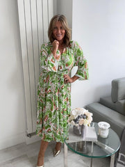 Plus size tropical bloom wrap midi dress for UK sizes 14–24 styled with sandals

