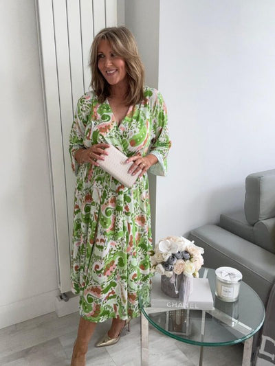 Plus size tropical bloom wrap midi dress for UK sizes 14–24 styled with sandals

