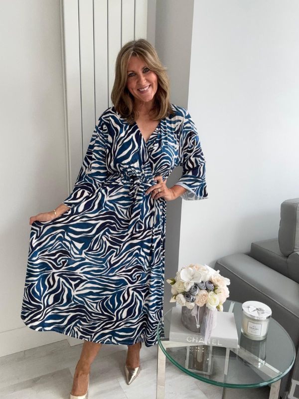 Plus size blue and white zebra wrap dress for UK sizes 14–24 styled with heels

