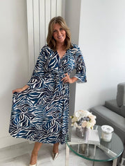 Plus size blue and white zebra wrap dress for UK sizes 14–24 styled with heels

