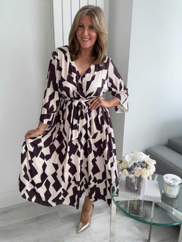 Plus size black and cream wrap midi dress for UK sizes 14–24 styled with heels