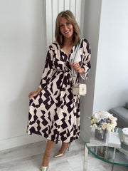 Plus size black and cream wrap midi dress for UK sizes 14–24 styled with heels
