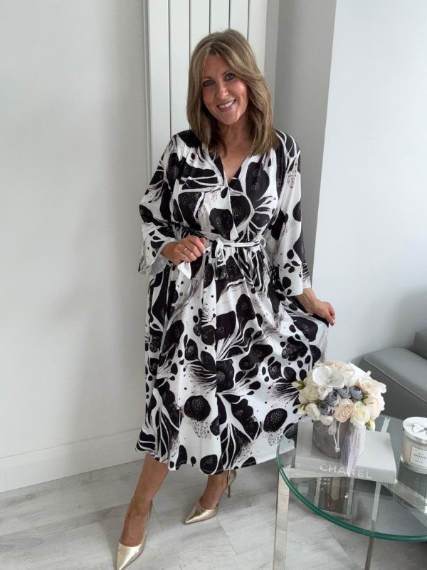 Plus size black and white wrap dress for UK sizes 14–24 styled with heels

