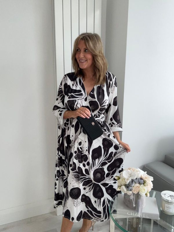 Plus size black and white wrap dress for UK sizes 14–24 styled with heels