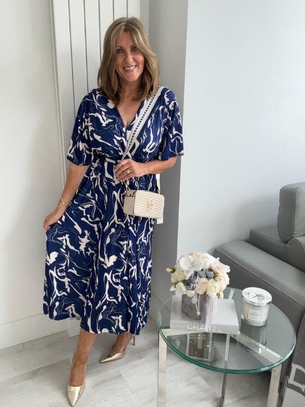 Lightweight navy abstract wrap dress for UK sizes 14–24 styled with heels