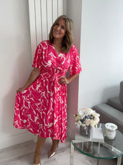 Lightweight bold pink abstract wrap dress for UK sizes 14–24 styled with heels
