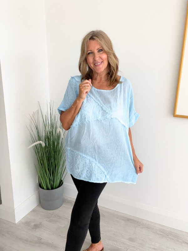 Brushed cotton and linen embroidered top with short sleeves and relaxed fit, displayed flat on neutral background