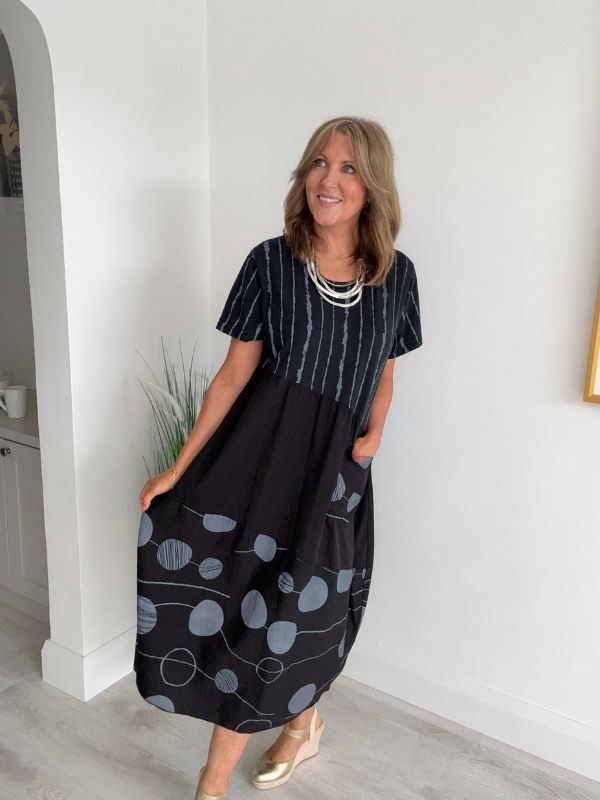 Model wearing Black cotton midi dress with navy polka dots and stripes – one size fits 8–18