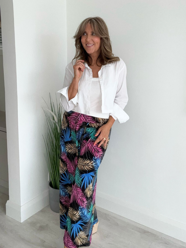 High-waisted tropical pants with elasticated waistband and flowing silhouette – styled with a white tank top