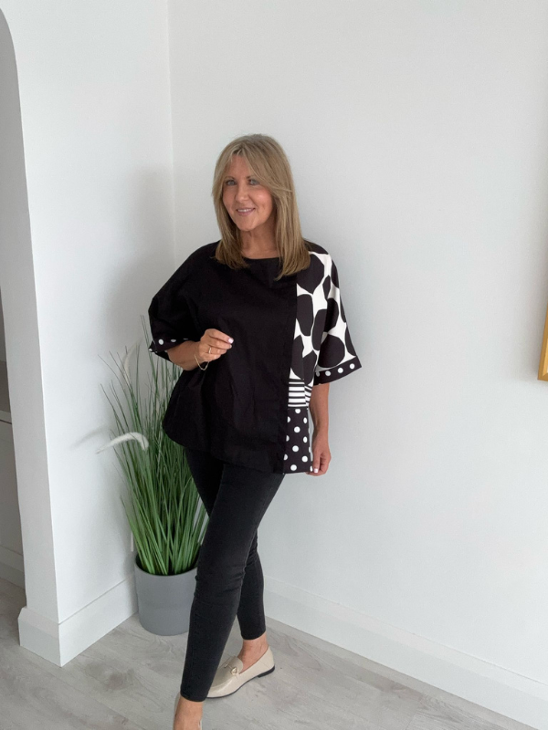 Plus size oversized blouse with polka dots and stripes, featuring asymmetric sleeves and modern abstract prints
