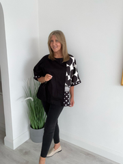 Plus size oversized blouse with polka dots and stripes, featuring asymmetric sleeves and modern abstract prints