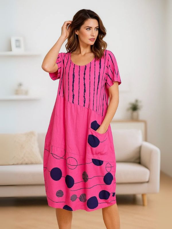 Model wearing Cerise Pink midi dress with navy polka dots and stripes – one size fits 8–18