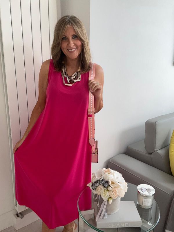 Plus-size women’s sleeveless swing midi dress in soft lightweight fabric, available in six colours including nude beige, hot pink, lavender purple, white, black, and taupe grey, designed for UK sizes 14–22.