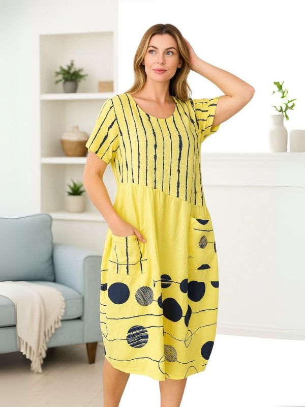 Model wearing Lemon midi dress with navy polka dots and stripes – one size fits 8–18
