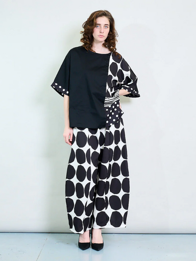 Plus size oversized blouse with polka dots and stripes, featuring asymmetric sleeves and modern abstract prints