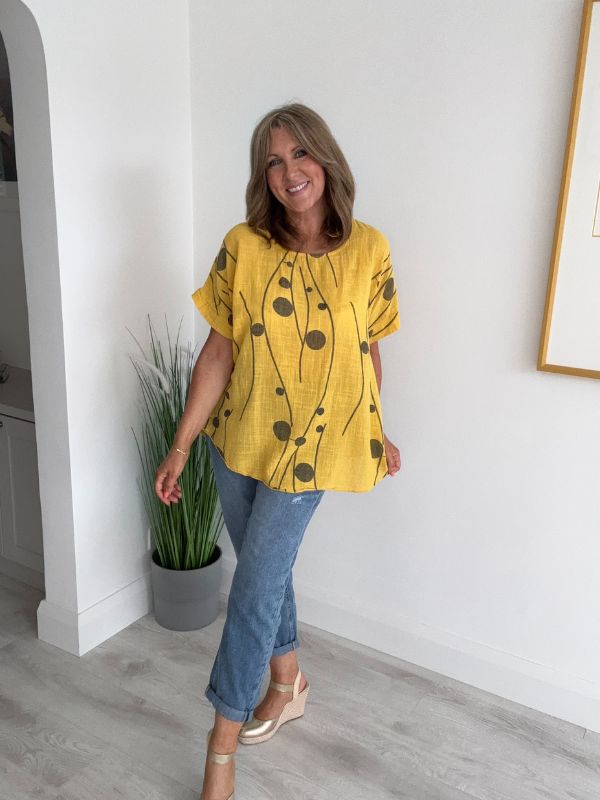 Women’s cotton half sleeve top with rolled cuffs, featuring a relaxed fit and abstract dot and vine print, available in vibrant colours and UK sizes 8–20.