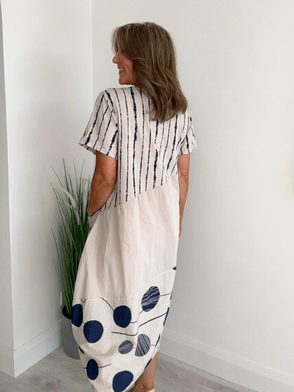 Model wearing natural cotton midi dress with navy polka dots and stripes – one size fits 8–18