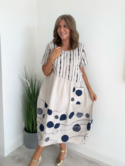 Model wearing natural cotton midi dress with navy polka dots and stripes – one size fits 8–18