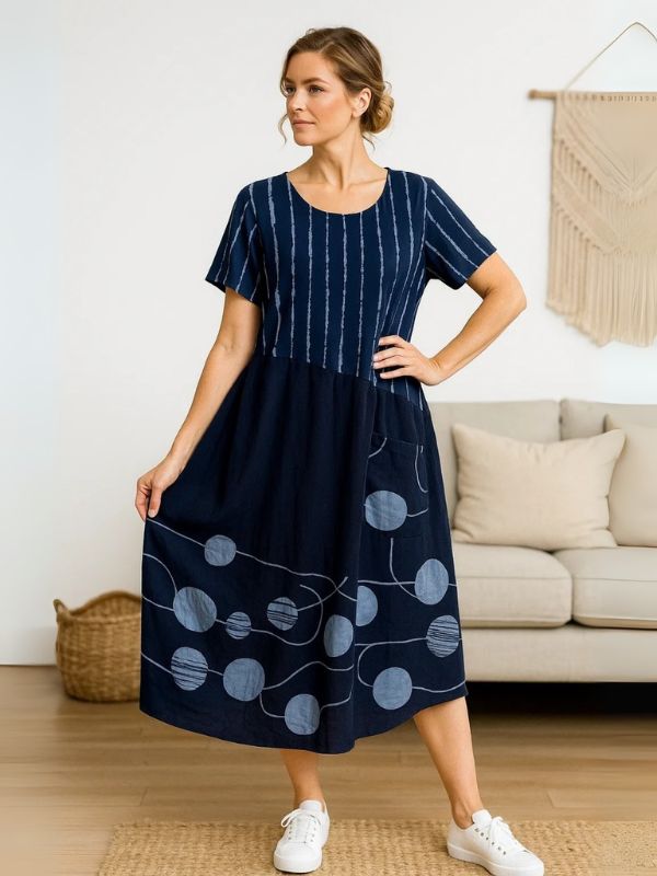 Model wearing Navy Blue midi dress with navy polka dots and stripes – one size fits 8–18