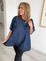 Vintage oversized denim blouse with abstract newspaper print on sleeves, round neckline, and high-low hem – 100% cotton, free size 8–20