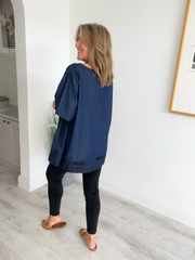 Vintage oversized denim blouse with abstract newspaper print on sleeves, round neckline, and high-low hem – 100% cotton, free size 8–20
