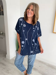 Women’s cotton half sleeve top with rolled cuffs, featuring a relaxed fit and abstract dot and vine print, available in vibrant colours and UK sizes 8–20.