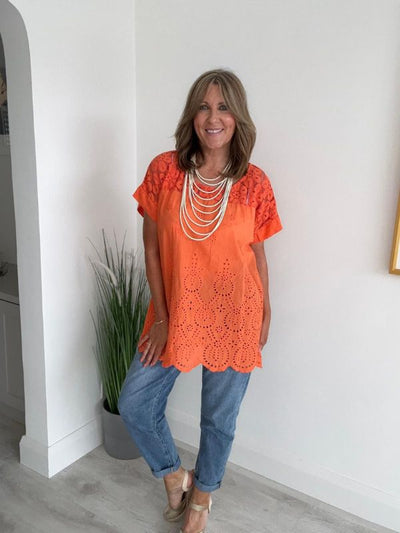 Lightweight cotton tunic top featuring delicate eyelet embroidery, scalloped hem, rounded neckline, and relaxed fit for UK sizes 8–18.
