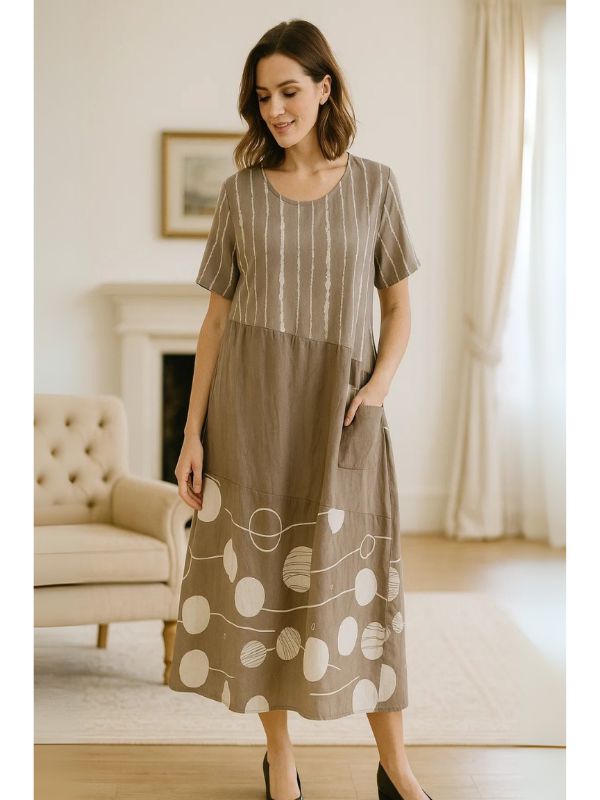 Model wearing Taupe Brown midi dress with navy polka dots and stripes – one size fits 8–18
