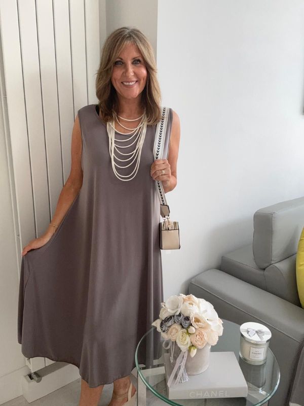 Plus-size women’s sleeveless swing midi dress in soft lightweight fabric, available in six colours including nude beige, hot pink, lavender purple, white, black, and taupe grey, designed for UK sizes 14–22.