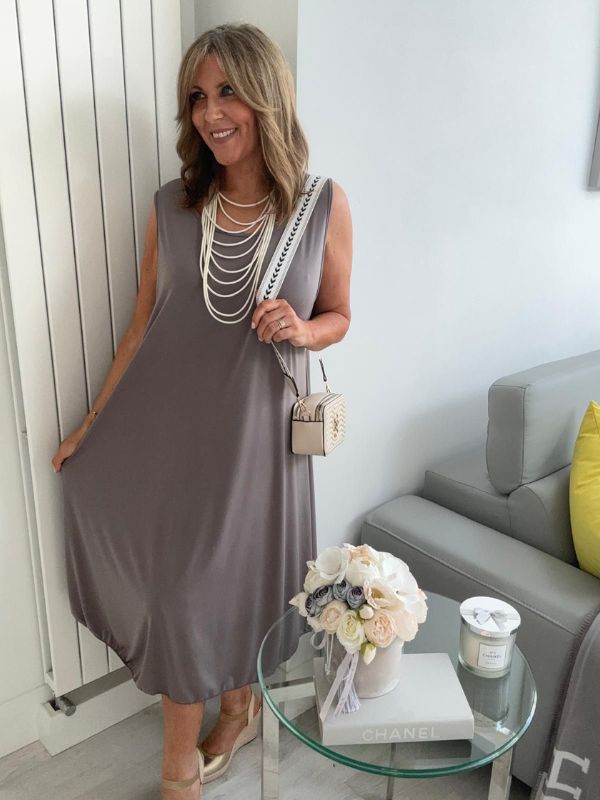Plus-size women’s sleeveless swing midi dress in soft lightweight fabric, available in six colours including nude beige, hot pink, lavender purple, white, black, and taupe grey, designed for UK sizes 14–22.