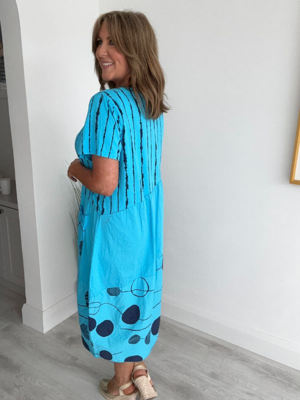 Model wearing Turquoise Blue midi dress with navy polka dots and stripes – one size fits 8–18